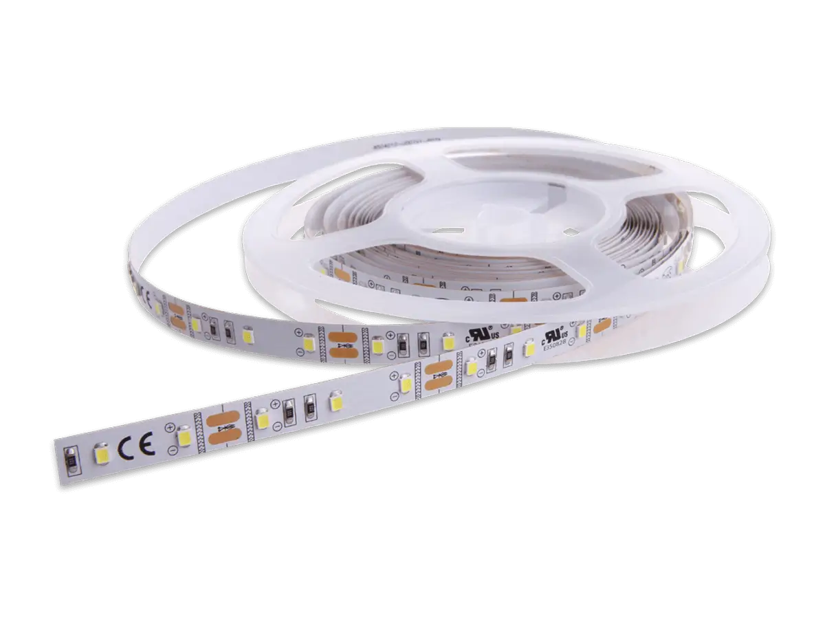 White flexible LED strip lighting partially unrolled from a reel.