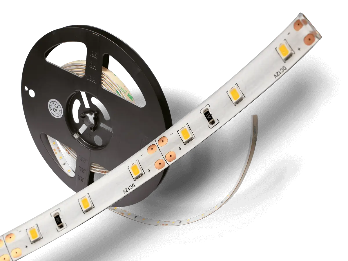 White FlexTape LED strip partially unrolled from a black reel.