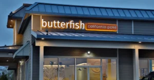 Illuminated Butterfish California Poke storefront sign featured in a Principal Sloan article about color in LED signage.