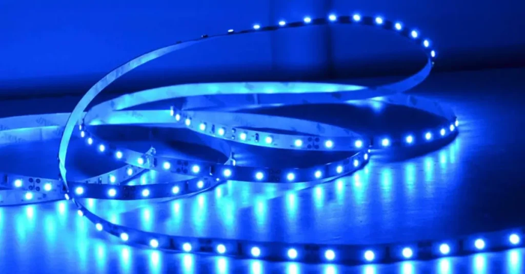 Illuminated blue LED light tape arranged in loose coils.