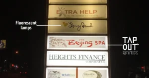 Illuminated tenant sign comparing fluorescent lamps with Tap Out Stik LED lighting.