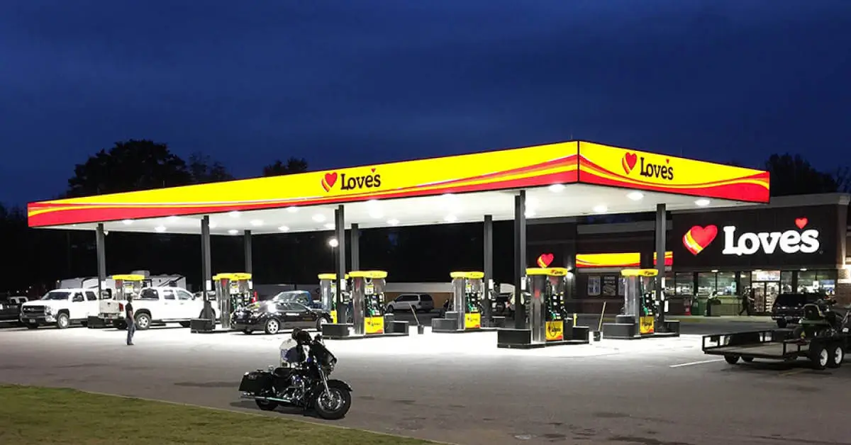 Illuminated Love’s Travel Stop canopy and storefront signage at night.